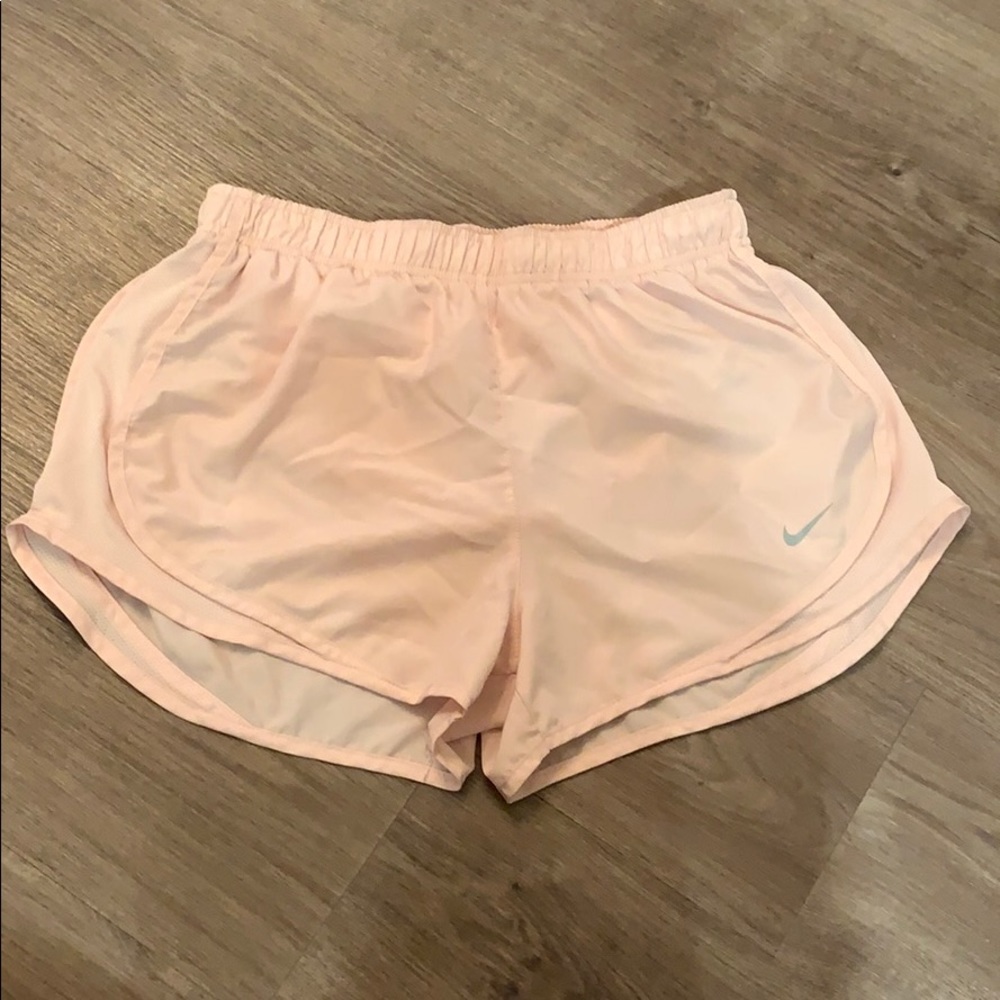 All light pink Nike running shorts